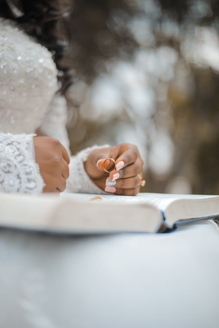 Crop Bride Holding Ring And Reading Wedding Vow