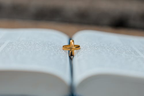 Golden rings on book during wedding day