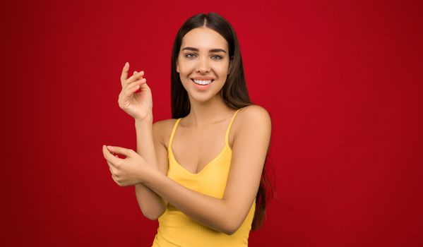 一位长发年轻女子在红色背景下微笑的肖像照