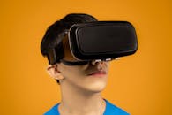 Man in Blue Crew Neck Shirt Wearing a VR Headset