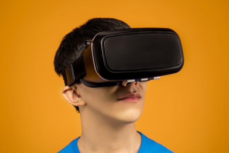 Man In Blue Crew Neck Shirt Wearing A VR Headset