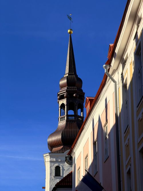Free A historic church tower against a clear blue sky in Tallinn, Estonia. Captured in vivid detail. Stock Photo