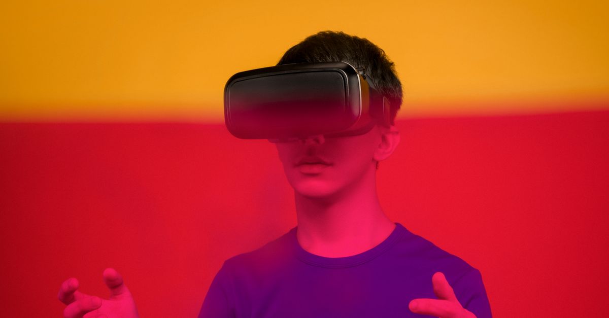 person wearing VR headset watching virtual concert with colorful lights