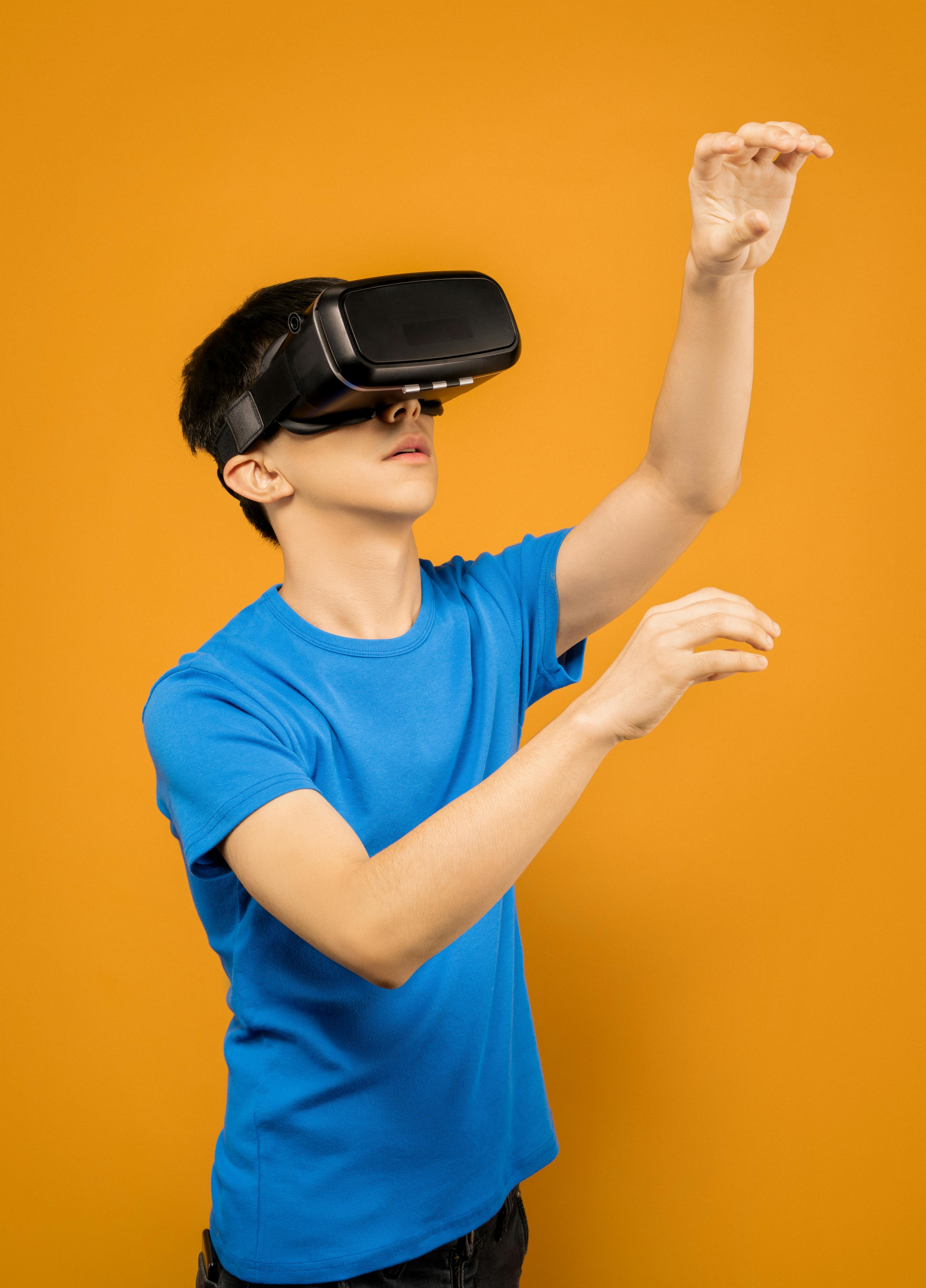 man in blue crew neck t shirt wearing black vr goggles