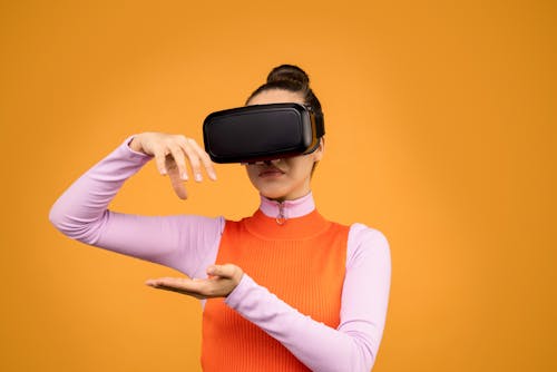Woman in Long Sleeve Shirt Wearing Black VR Goggles