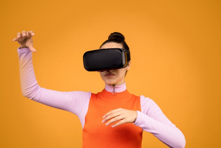 Woman In Orange And Pink Sweat Shirt Wearing Vr Goggles