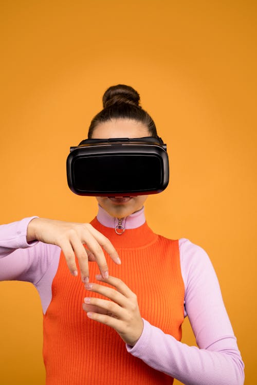 Free Woman in Long Sleeve Shirt Wearing Black VR Goggles Stock Photo