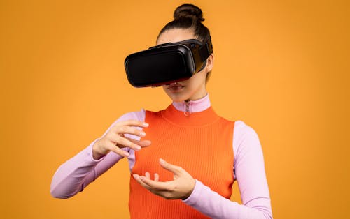 Free Woman in Long Sleeve Shirt Wearing Black VRGoggles Stock Photo