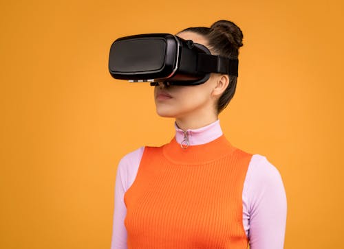 Woman in Long Sleeve Shirt Wearing Virtual Reality Headset