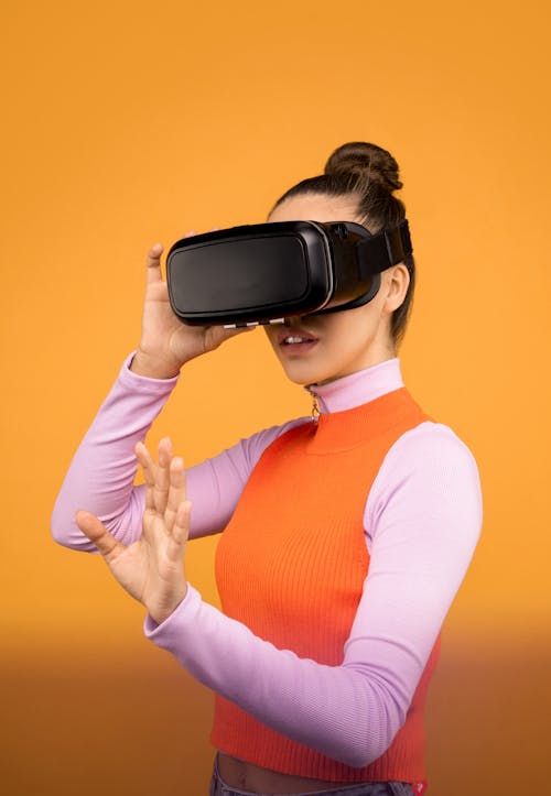 Woman in Long Sleeve Shirt Wearing Black VR Headset