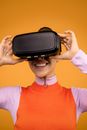 Woman in Long Sleeve Shirt Putting On Her VR Headset