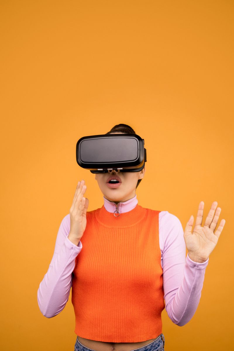 Woman immersed in virtual reality, wearing a VR headset against a vibrant orange background.