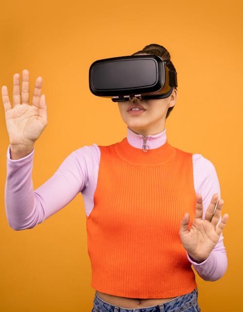 Woman in Long Sleeve Shirt Wearing VR Goggles