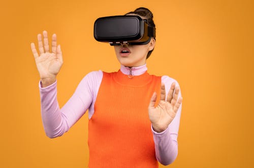 Woman in Long Sleeve Shirt Wearing VR Goggles