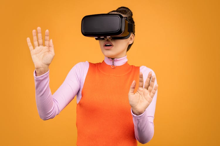 Woman In Long Sleeve Shirt Wearing VR Goggles