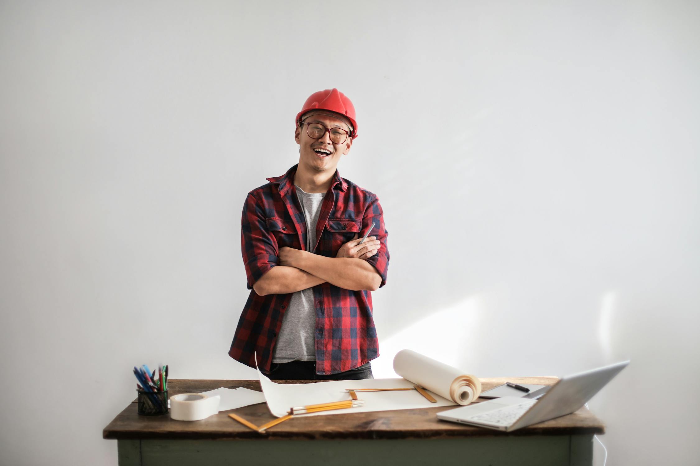 man in hard hat with paper on table