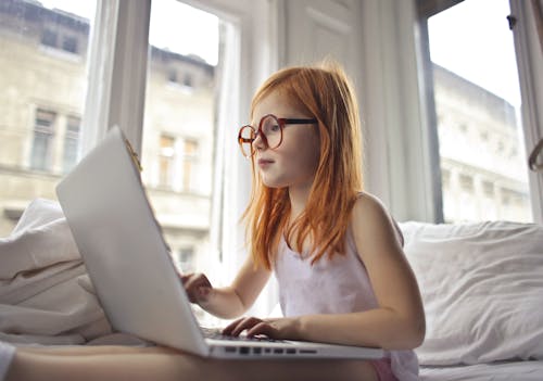 Free A Girl Watching Movie On Computer Laptop Stock Photo