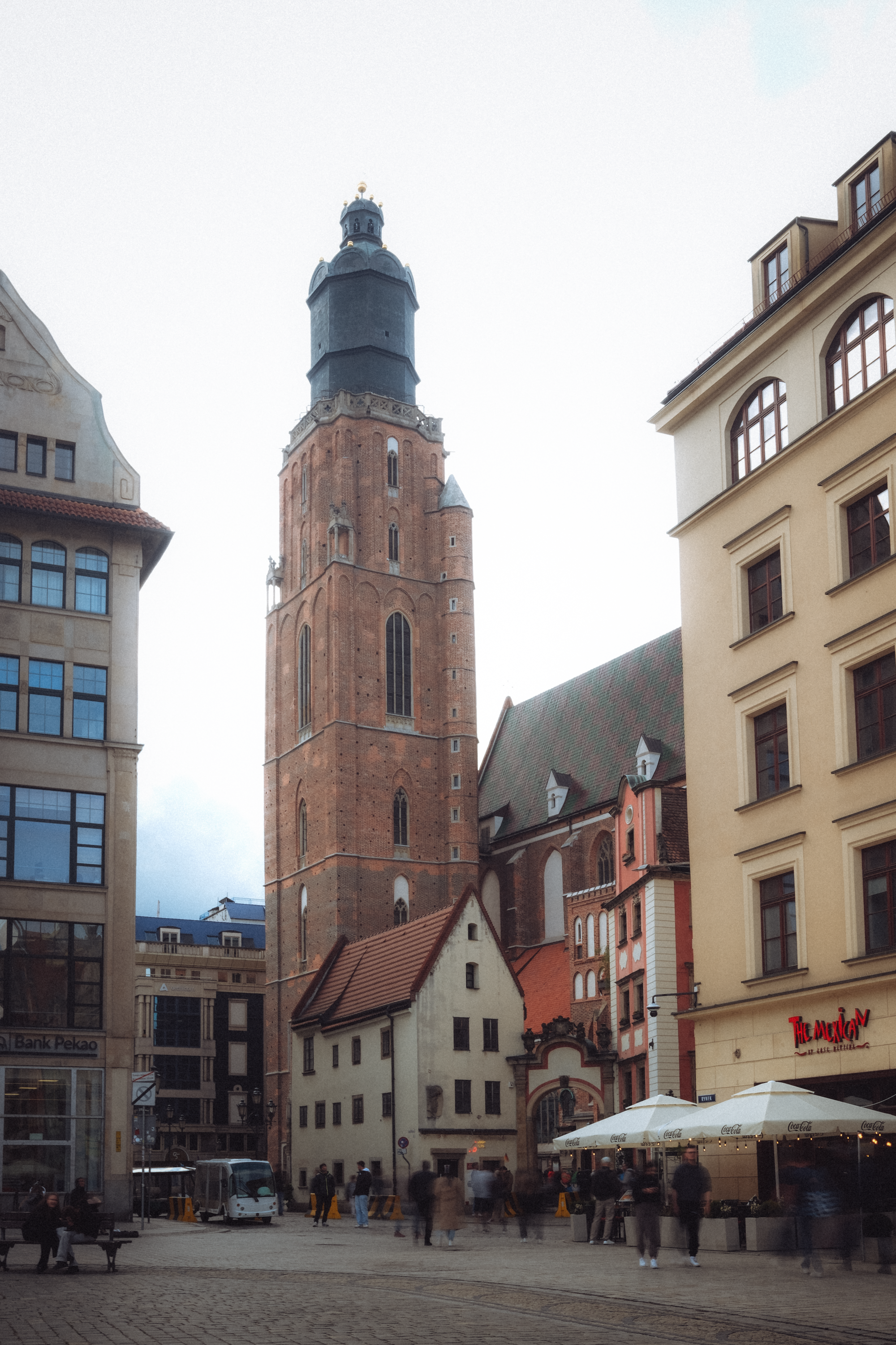View of a historic church tower and surrounding architecture in Wrocław, Poland's main square.