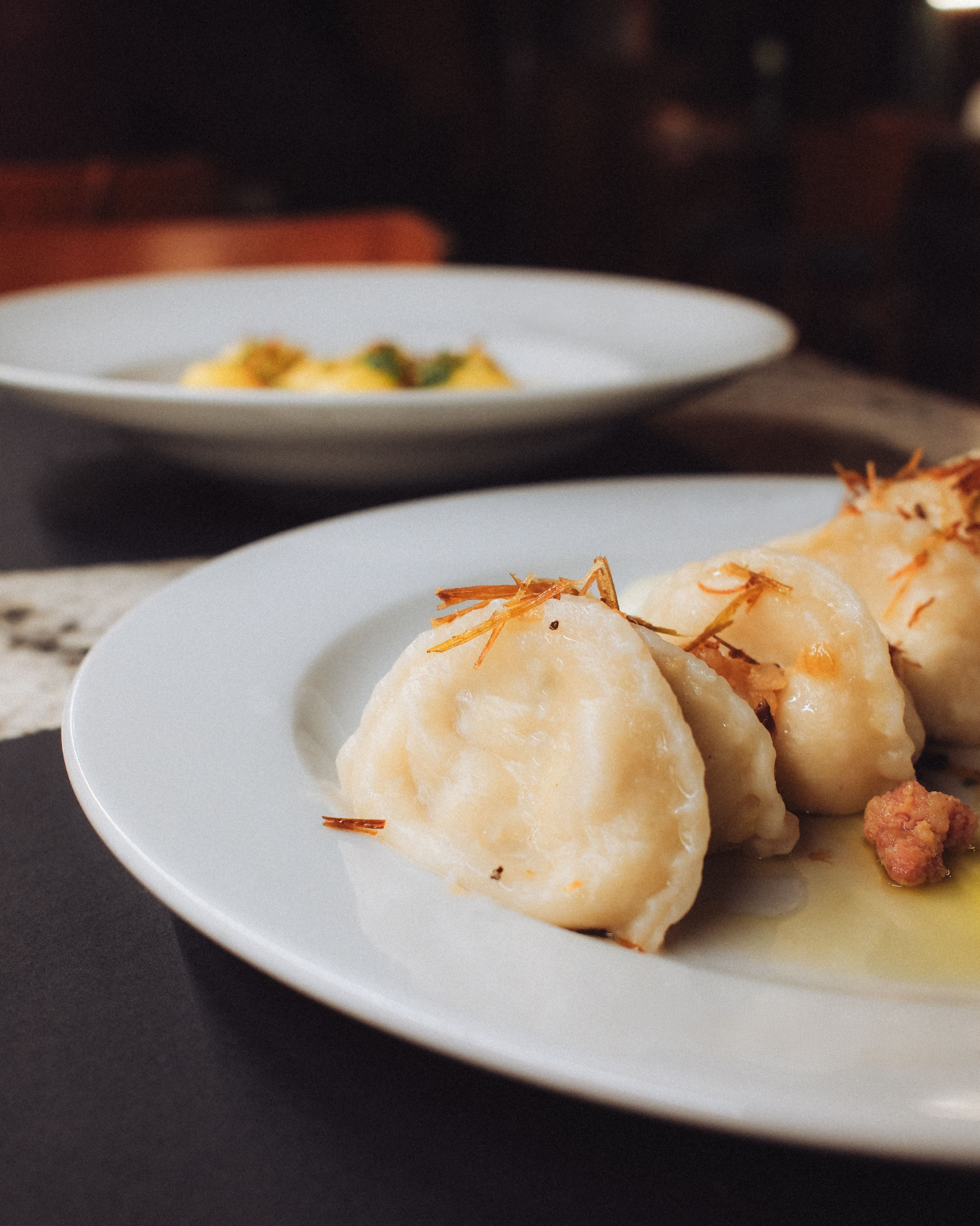 Hand-folded dumplings filled with mashed potato and farmer's cheese, pan-fried in butter.
