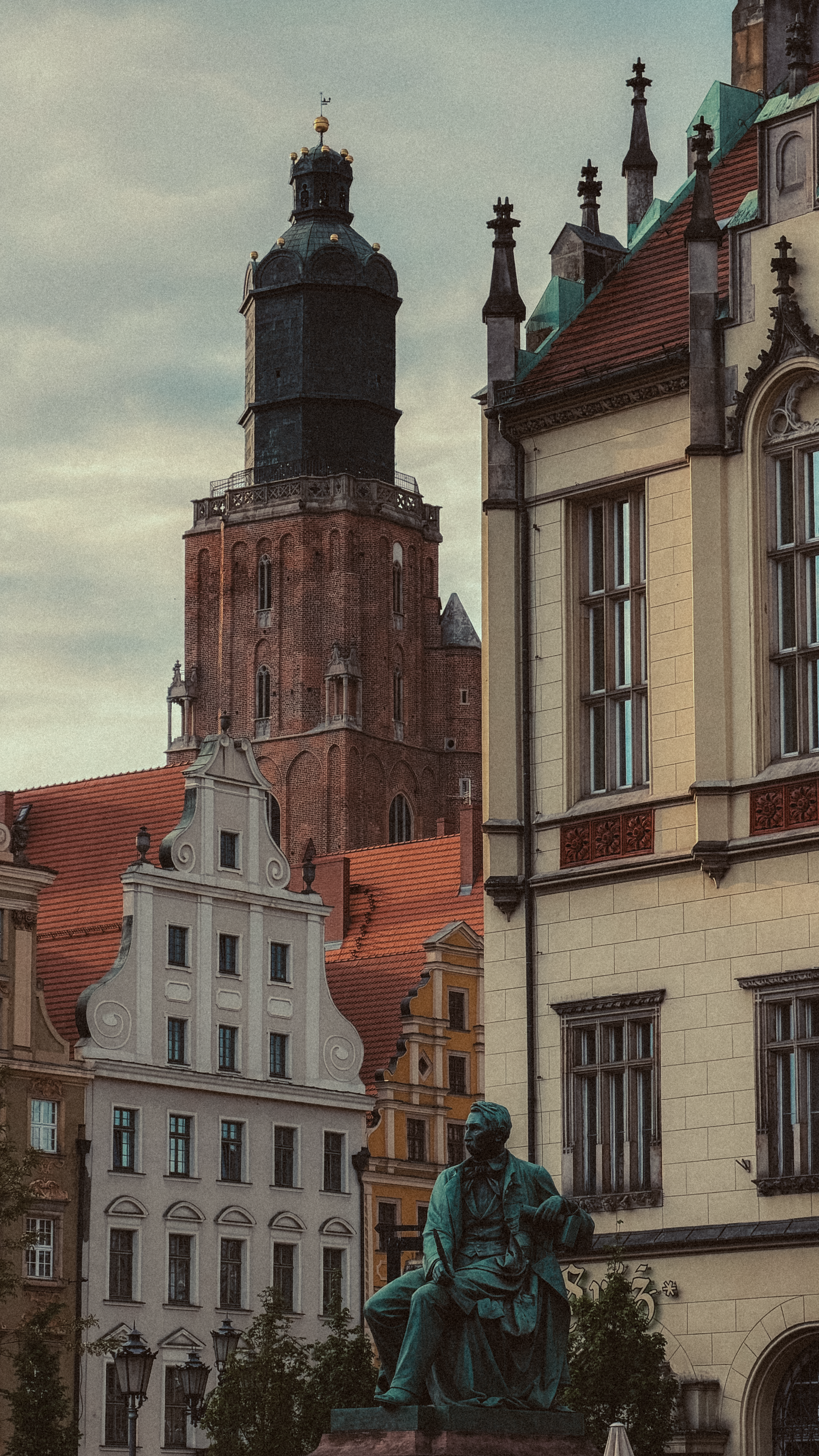 Explore Breslau's rich architecture featuring a statue and Gothic buildings in Niederschlesien, Poland.