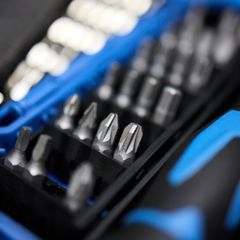 Close-up of screwdriver bits in the black insert of a blue plastic bit case