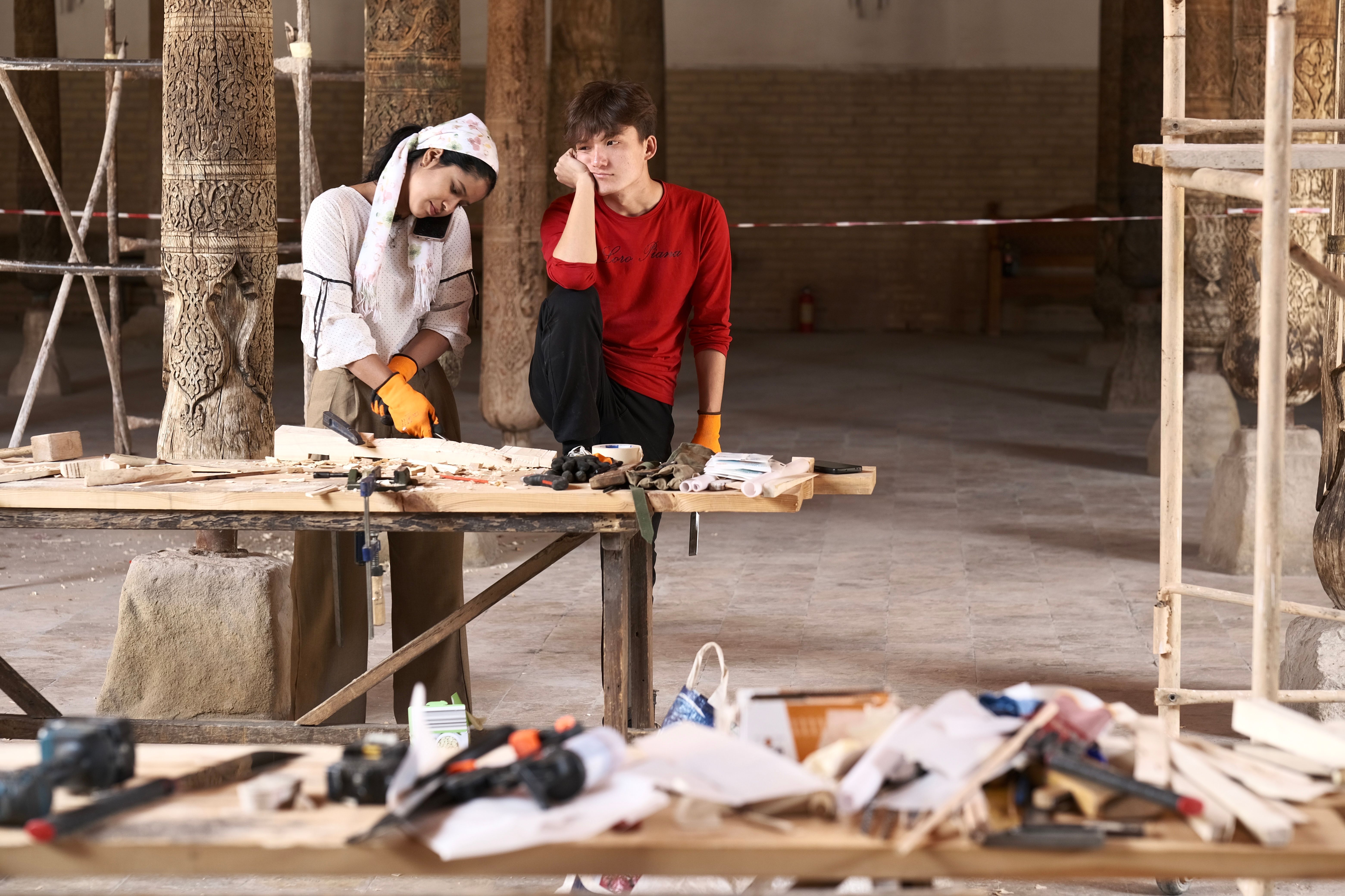 Two workers engage in mosque restoration work in Bukhara, Uzbekistan.