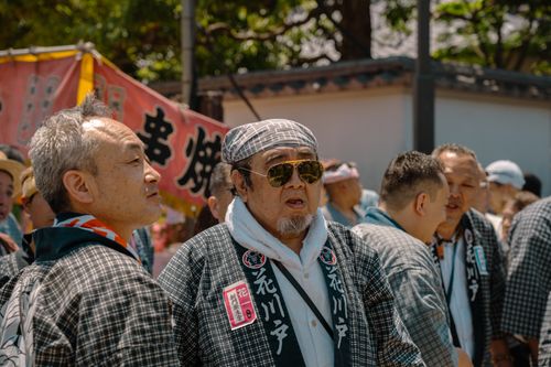 Free Men dressed in traditional attire participate in a vibrant Tokyo festival. Stock Photo