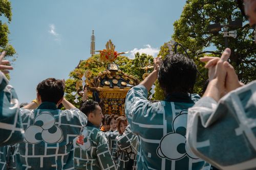 Free Participants carrying a mikoshi during a vibrant festival in Tokyo, Japan. Stock Photo
