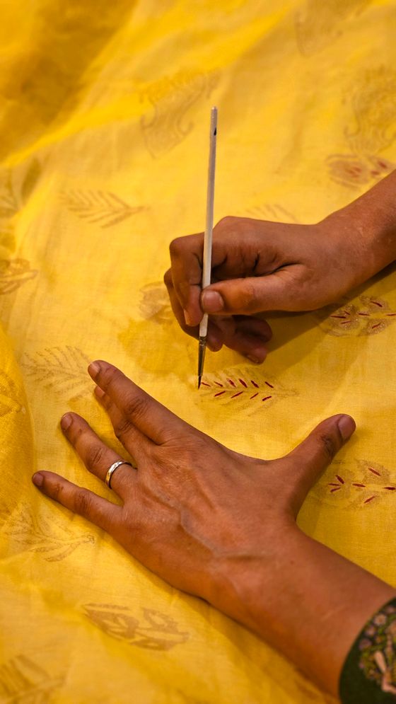 Hand-blocking a length of cloth — photo by Muhammad Khawar Nazir on Pexels