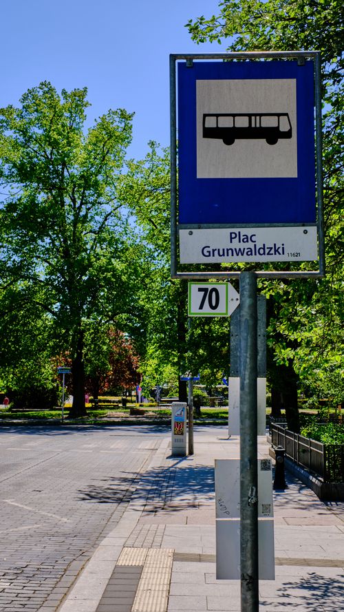 Free Street view of a bus stop sign at Plac Grunwaldzki, Wroclaw, on a sunny day. Stock Photo
