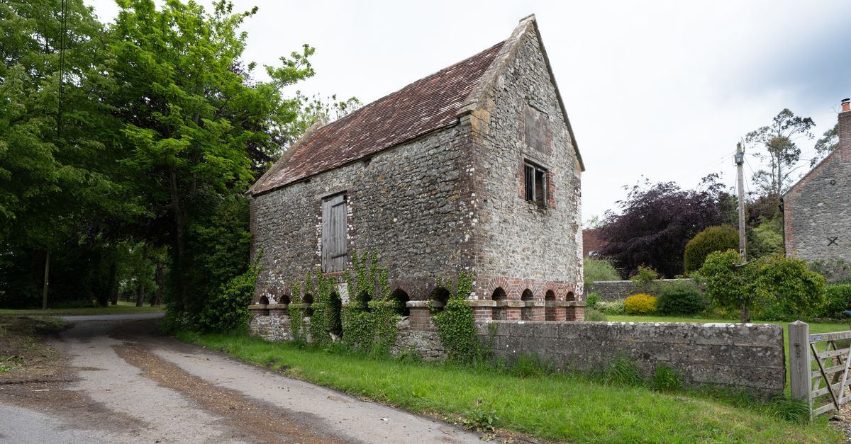 Stone building amidst greenery, perfect for historical and rural themes.