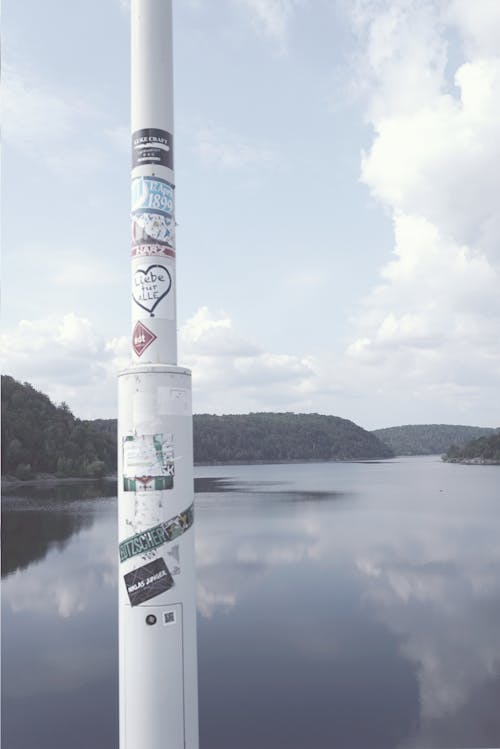 Free stock photo of flag poles, lake, masts Stock Photo