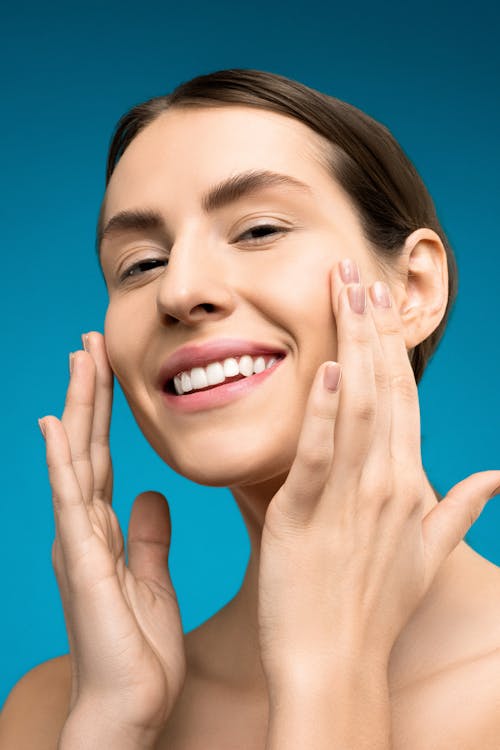 Free Smiling Woman With Both Hands on Her Face Stock Photo