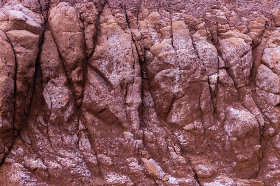 Close-up of eroded craggy rock formation in Melbourne, showing layered texture and rugged geology.