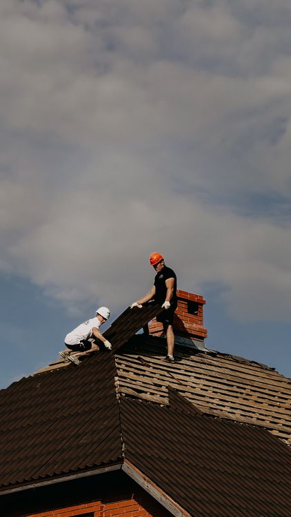roofer working on residential roof professional service