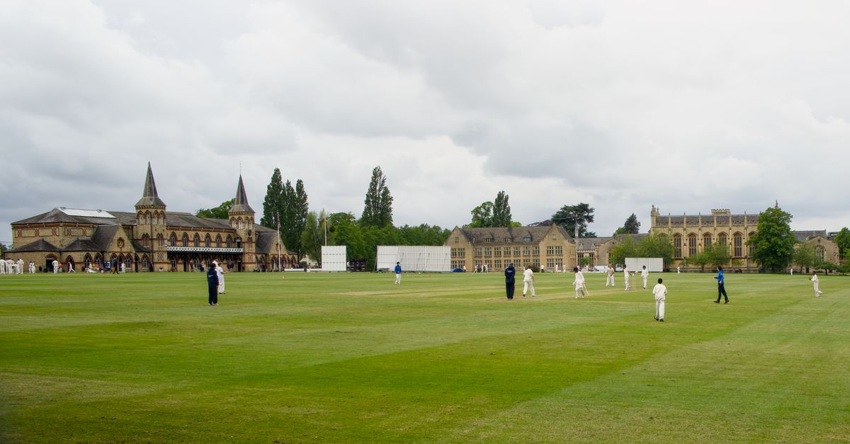 Jos Buttler raises his bat after scoring a century, celebrating with Harry Brook.