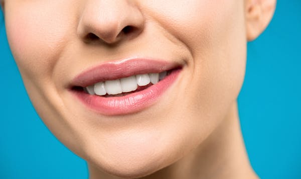 A woman with symmetrical lips smiling