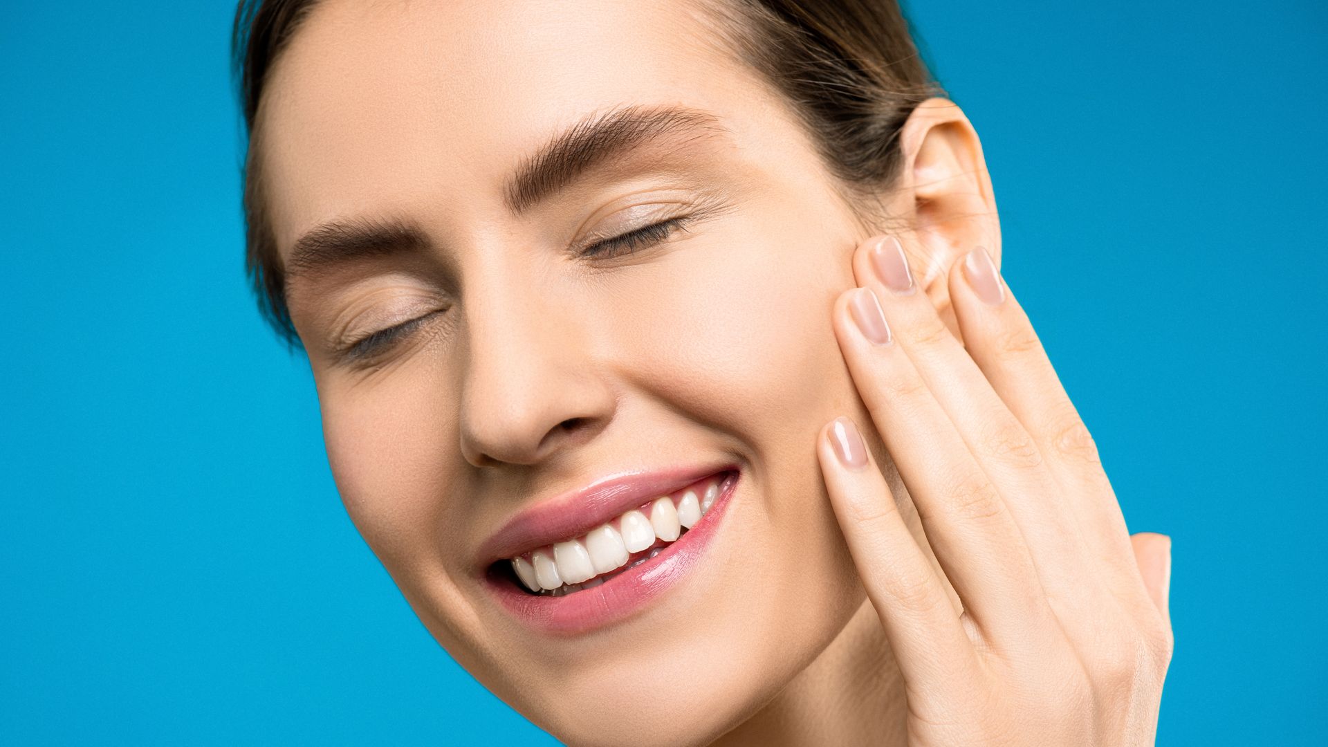 Best Maximising Benefits: Modafinil's Comprehensive Guide Portrait of a smiling woman with closed eyes against blue background — best maximising benefits