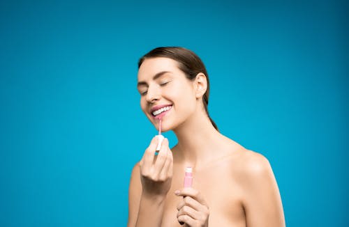 Free Woman With Pink Lipstick Holding Her Lip Stock Photo