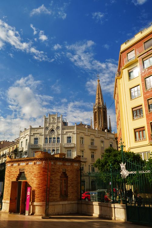 Free Charming cityscape featuring historic architecture under a bright, blue sky. Stock Photo