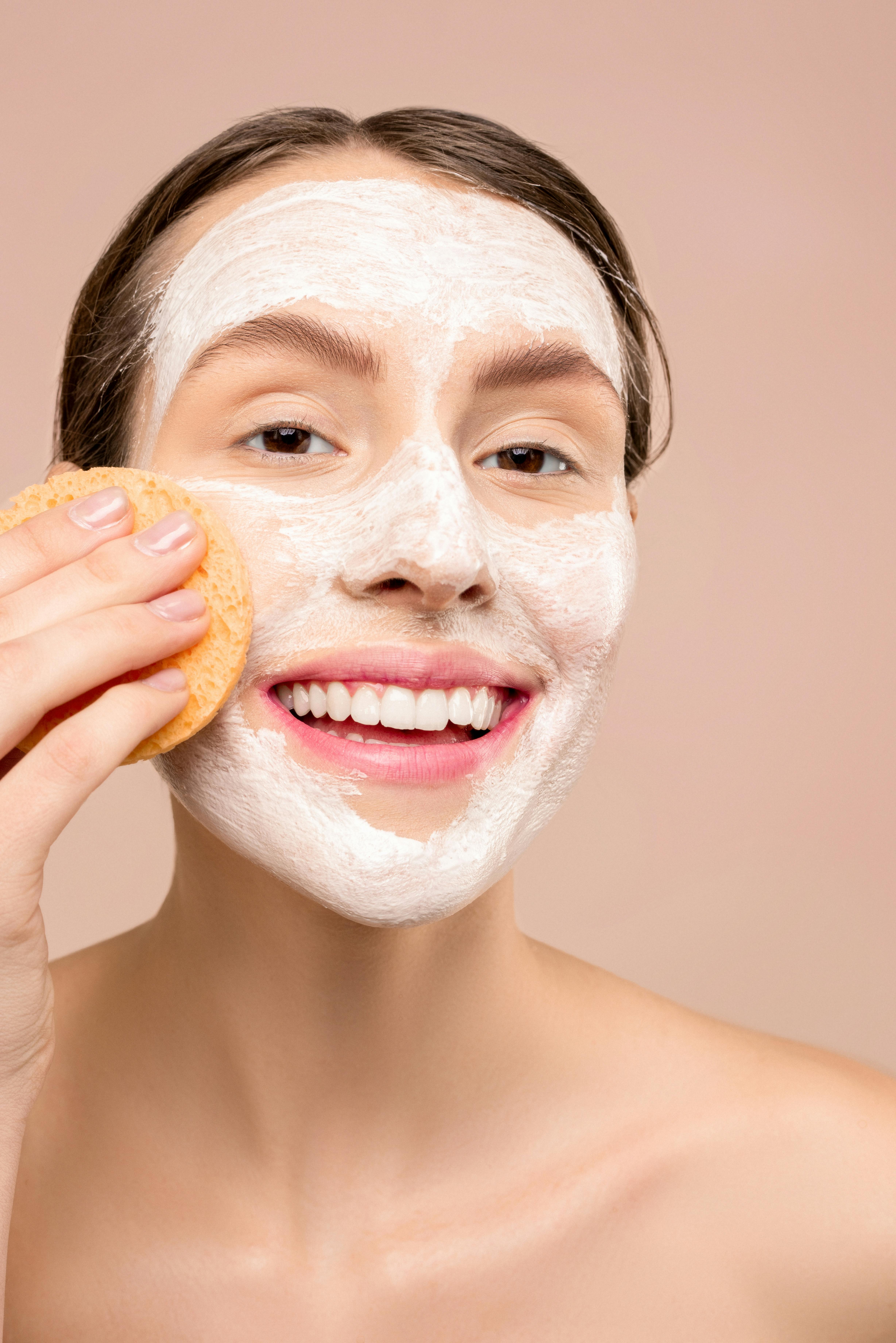 woman with white facial wash on face