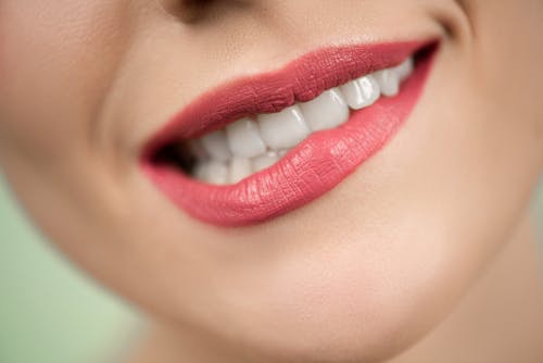 Woman With Red Lipstick Biting Her Lips