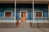 Charming colonial facade with wooden door in Pacasmayo, Peru.