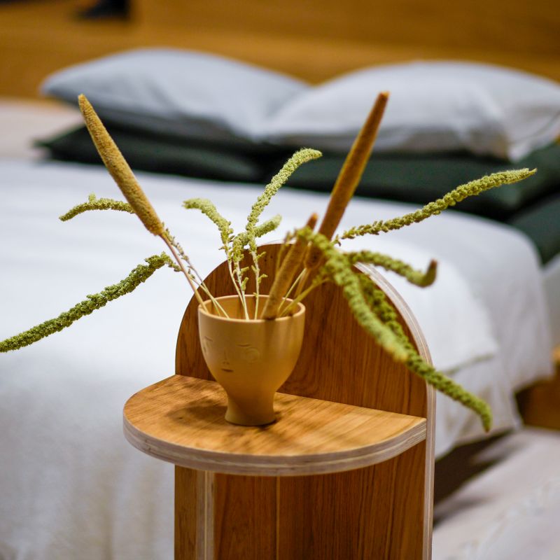 Bedroom with linen bedding and a plant
