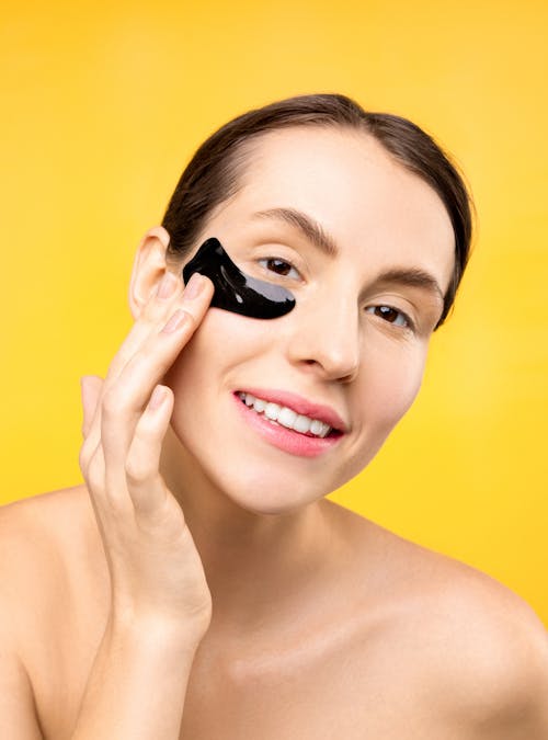 Free Woman With Black Under Eye Mask Smiling Stock Photo