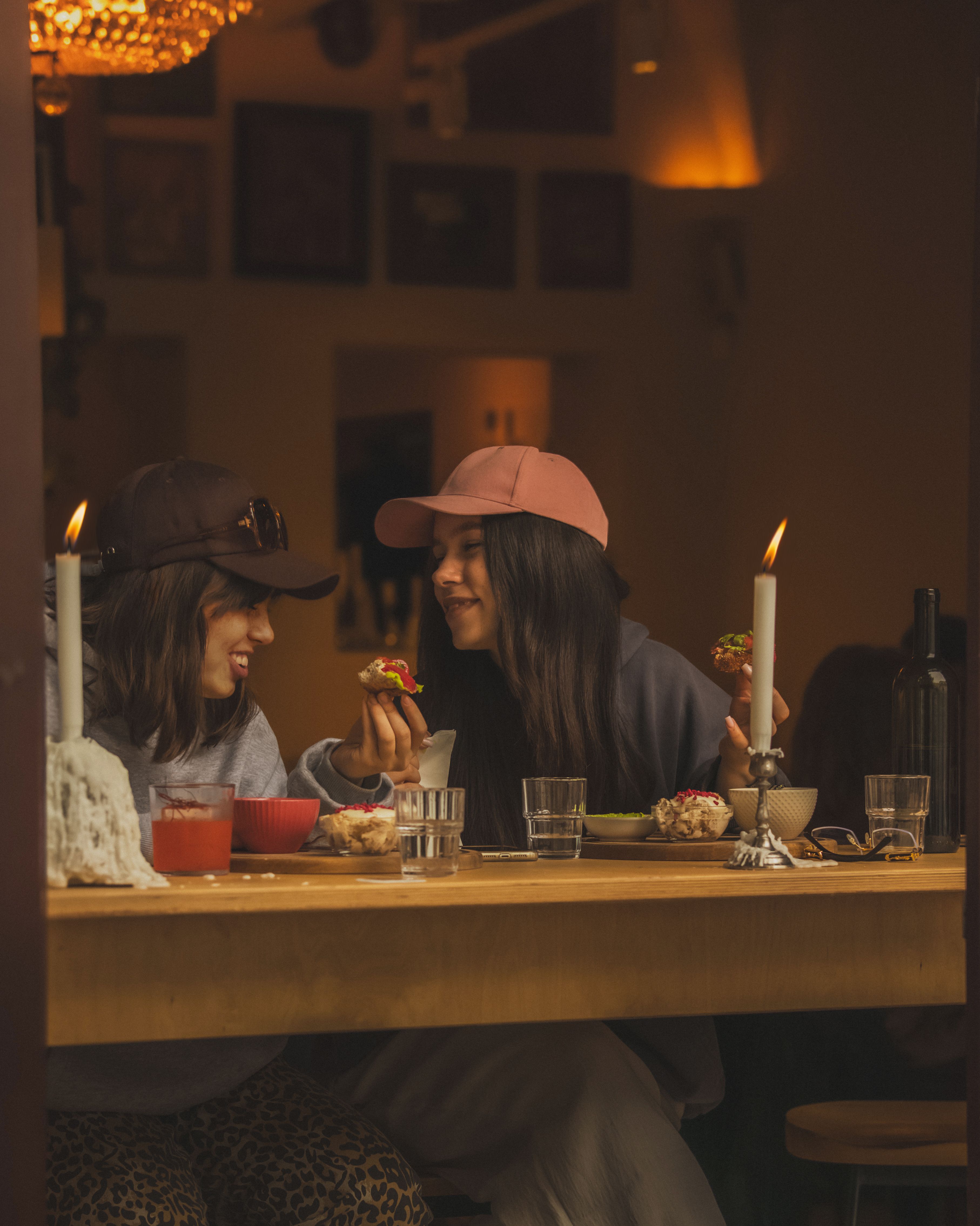 Two friends enjoying a meal together in a cozy Warsaw cafe, sharing smiles and conversations.
