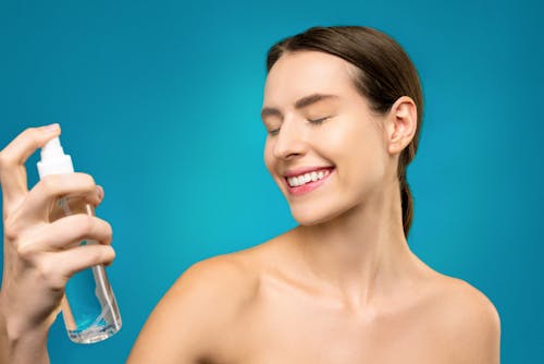 Free Woman Holding Clear Glass Bottle Stock Photo
