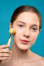 Woman Using Facial Roller
