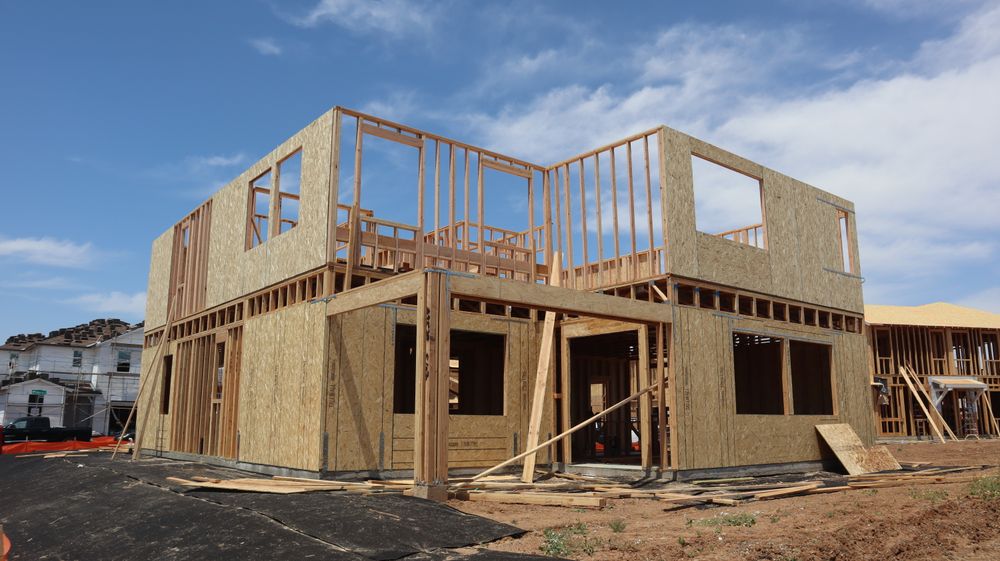 Two-story timber-framed building under construction