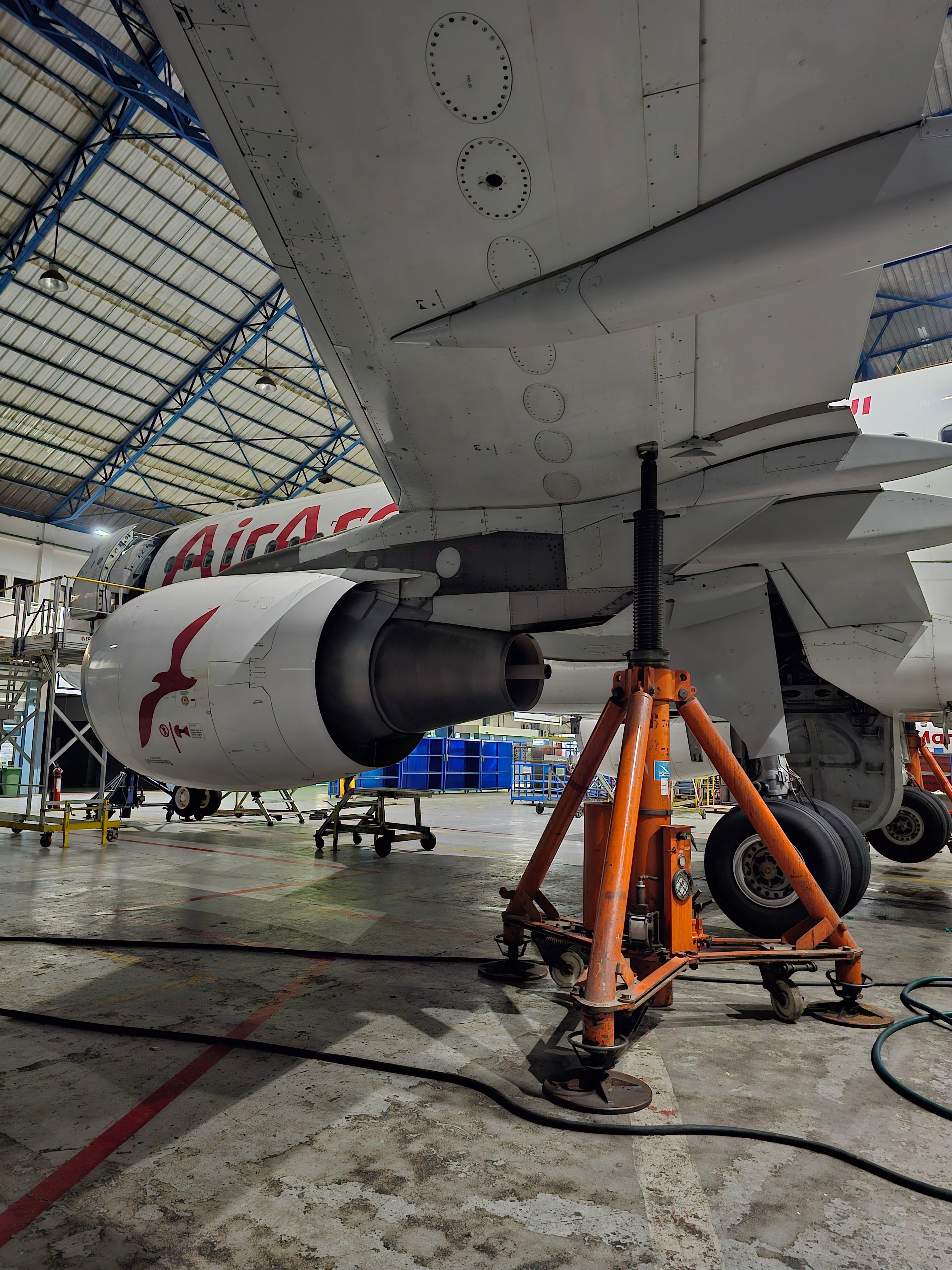Detailed view of an airplane under maintenance in an indoor hangar.